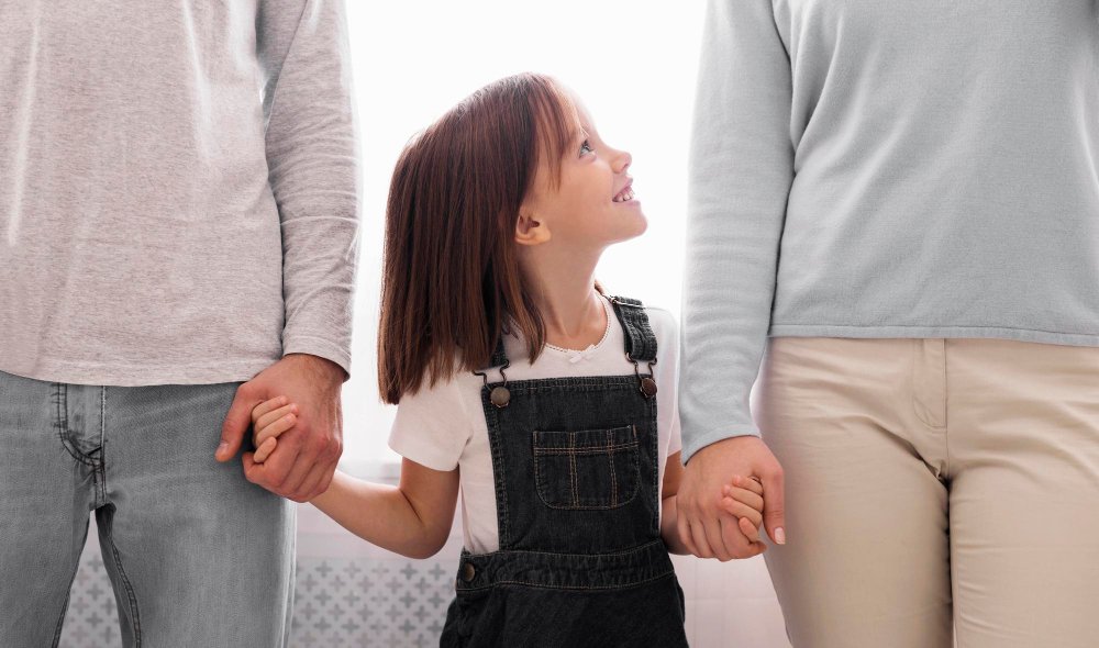 mother and father holding child calmly - emotional safety in childhood
