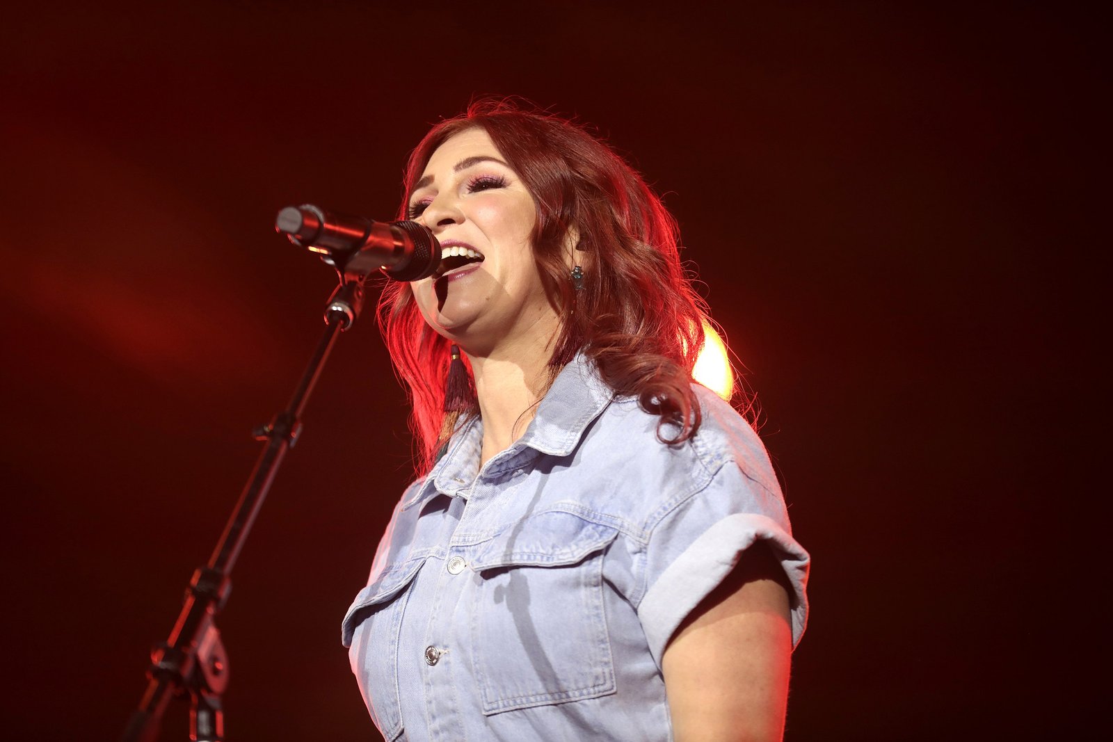 Kim Walker-Smith leading worship passionately on stage with eyes closed