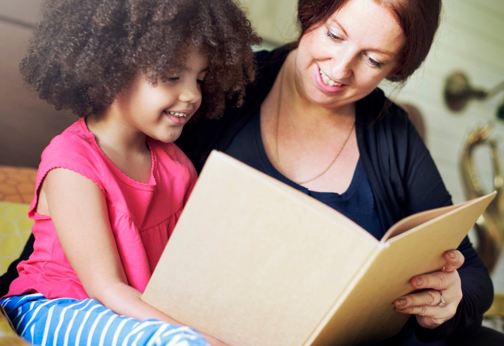 mother helping child with signs of dyslexia in children - early reading support
