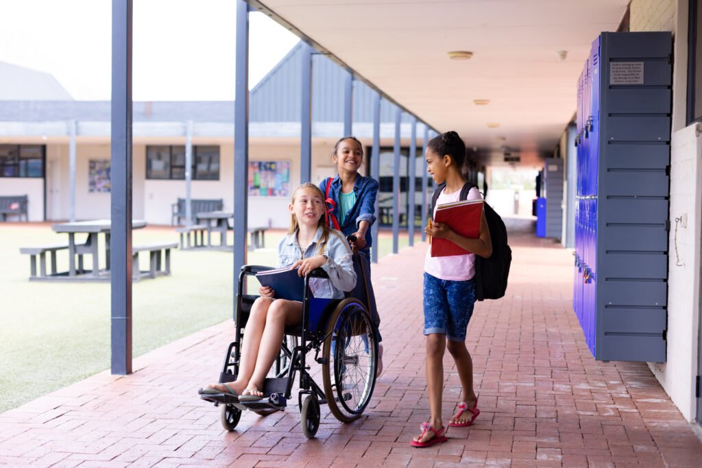 An accessible school campus with diverse female students, including one in a wheelchair, symbolizing safety, equity, and ADA-compliant facilities.