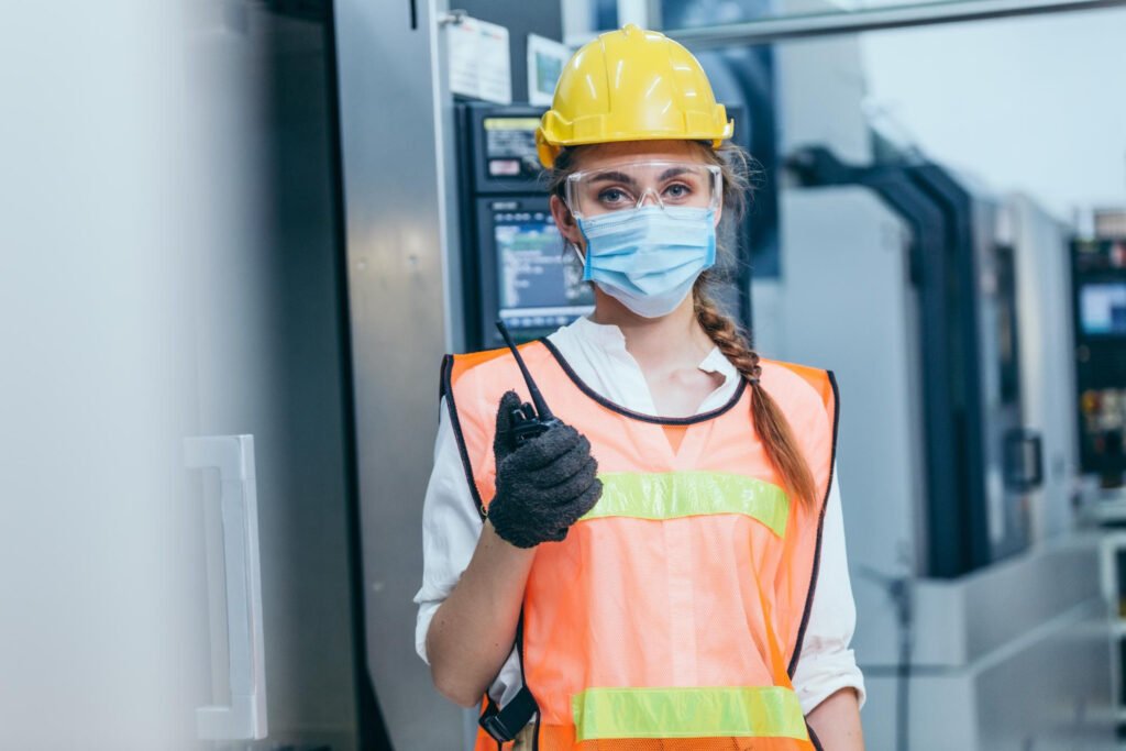 Facility worker ensuring safety compliance with PPE